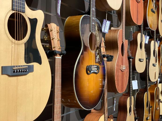 closeup photo of hanged guitars